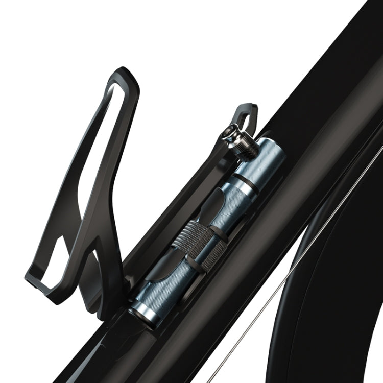 Portable mini bicycle pump mounted near a bike wheel with thumbtube style handle