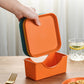 Plastic plate organizer base, orange, holding stacked plates