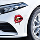 Red lip sticker with gold bullet on car fender