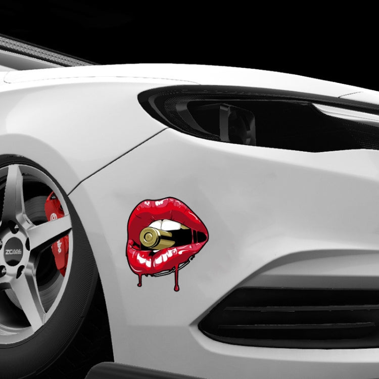 Red lip sticker with gold bullet on car side panel near wheel