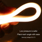 Hand holding a glowing LED strip loop with bright warm light