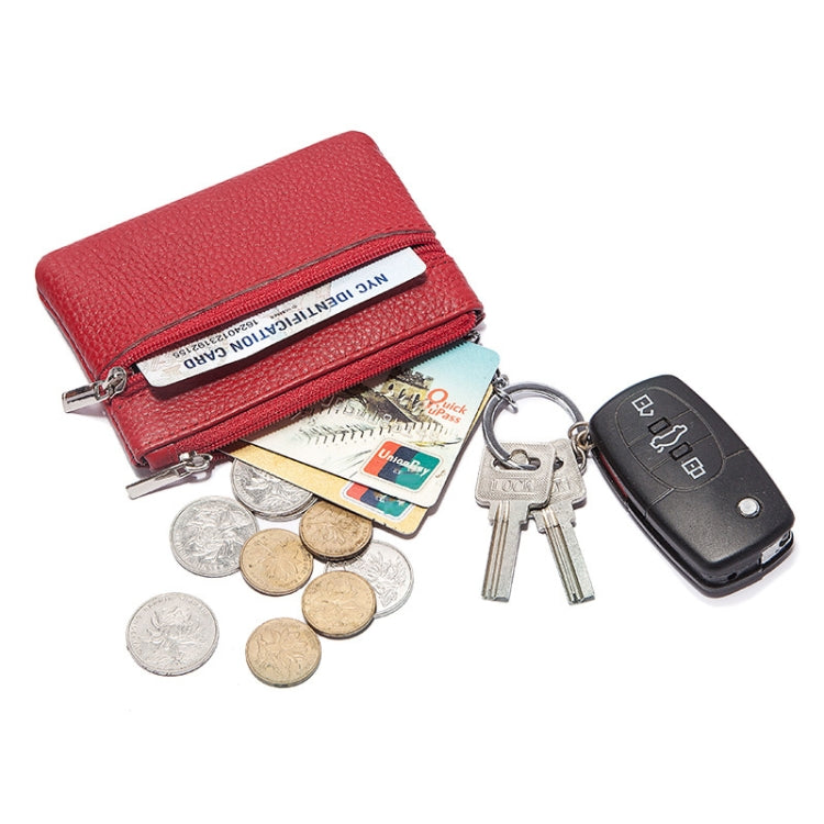Red leather mini wallet holding coins, cards, and keys with a keychain ring.