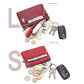 Red leather mini wallet with coins, cards, and keys shown inside zip pockets.