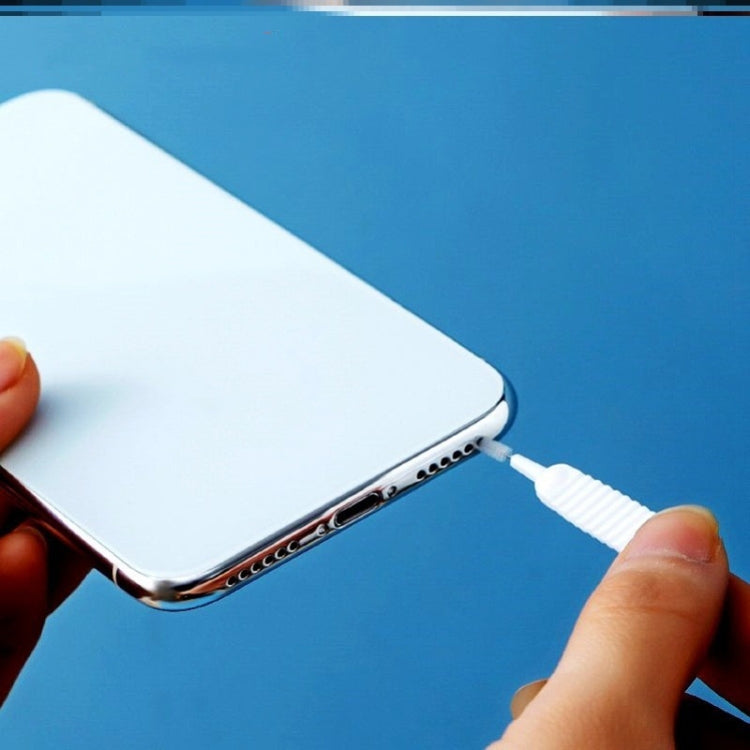 White shower hole cleaning brush used to clean small openings on a phone