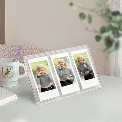 Clear three-slot vertical photo frame holding three square pictures