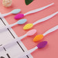 Set of silicone cleaning brushes with assorted colored heads on white handles
