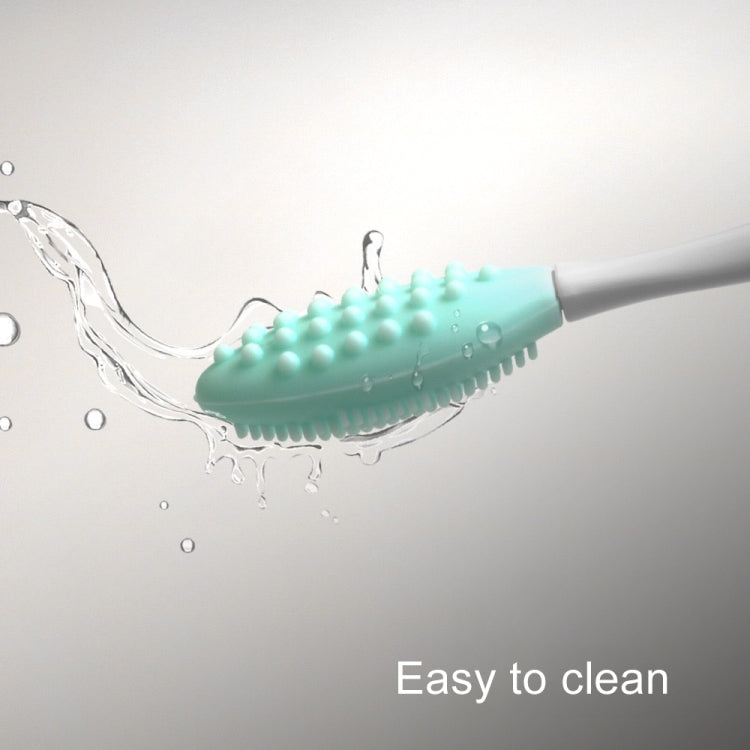 Silicone cleaning brush with teal textured head, water spraying from bristles