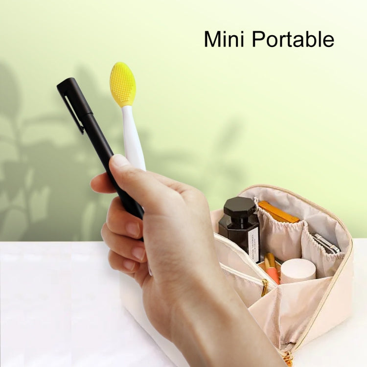 Mini portable silicone cleaning brush with yellow textured head and white handle