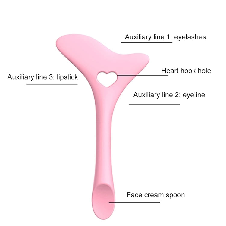 Pink silicone eyelash and eyeliner drawing guide with heart cutout and long spoon handle
