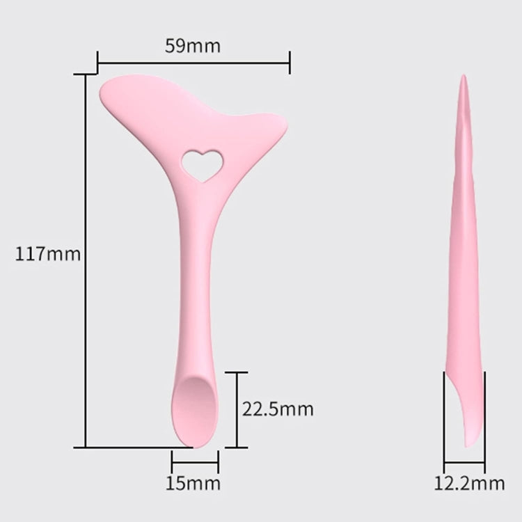 Pink silicone eyeliner drawing aid with heart center and spoon tip, size markers