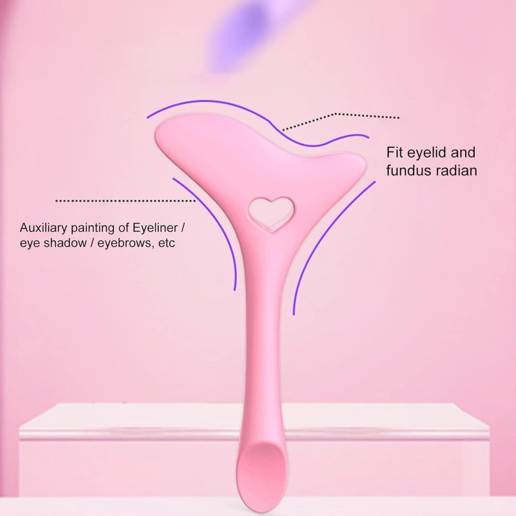 Pink silicone eyeliner guide tool with heart cutout for under-eye lining