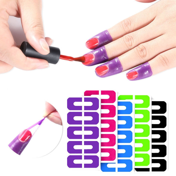 Hands applying nail polish over purple U-shaped protector stickers on nails