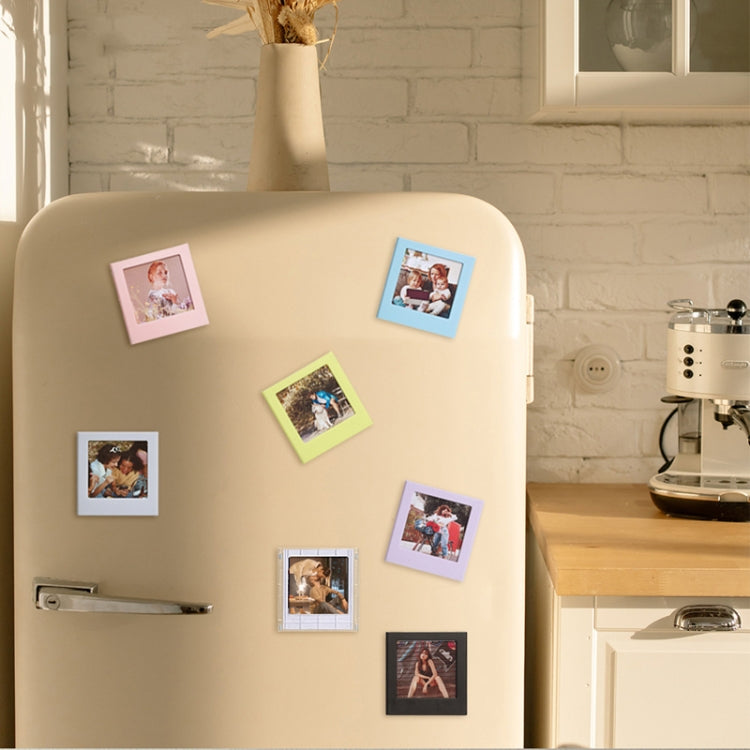 Square magnetic photo frame blocks on a refrigerator, holding multiple photos
