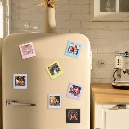 Square magnetic photo frame blocks on a refrigerator, holding multiple photos
