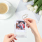 Hand inserting a photo into a clear square magnetic photo frame block
