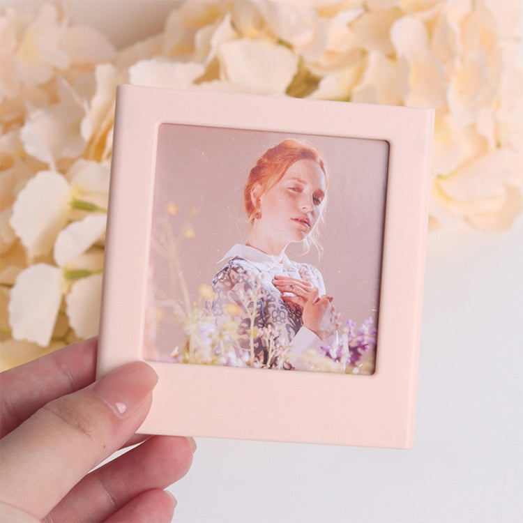 Pink square magnetic photo frame block holding a portrait photo