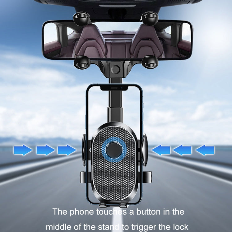 Black rearview mirror phone holder with circular textured lock pad for phone placement