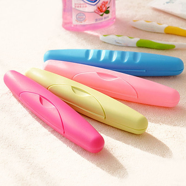 Set of travel toothbrush cases with lids in pink, blue, and yellow