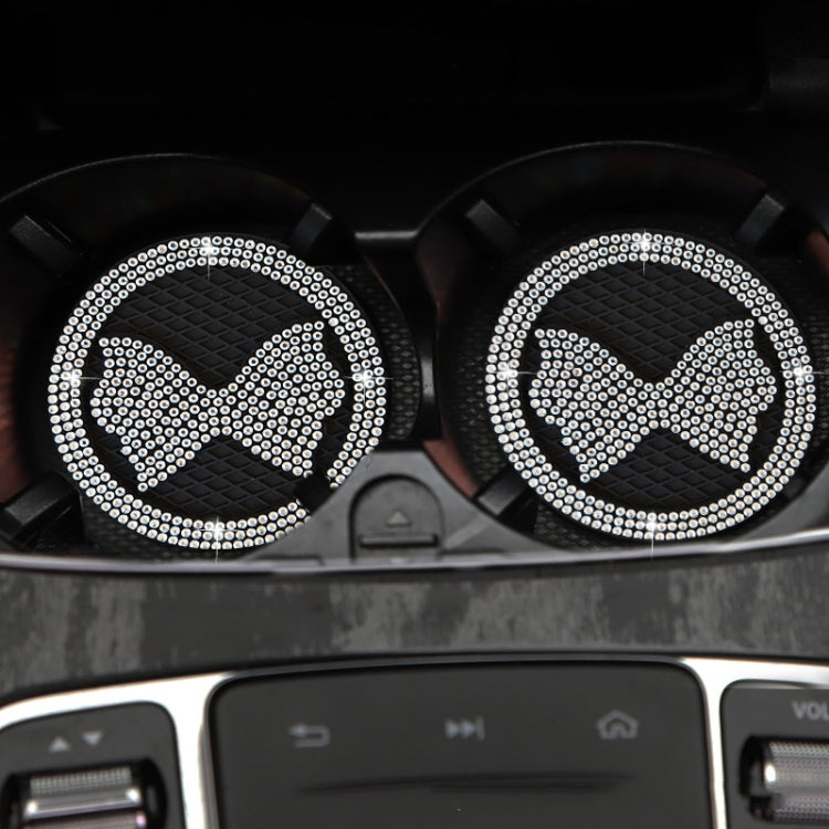 Two car anti-slip coasters with diamond-bow crystal, white rhinestones on dark mats