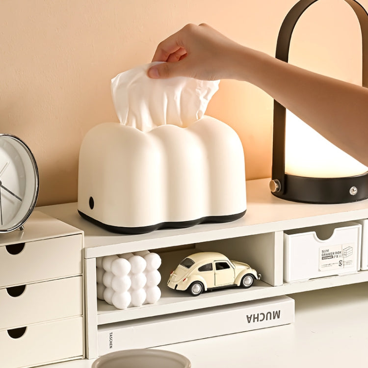 Cream cloud-shaped tabletop tissue box holder with tissue being pulled from top opening