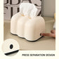 Cream cloud tissue holder dispensing tissue; press-separation design shown in use