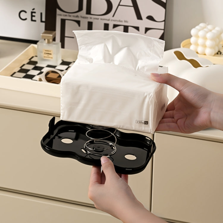 Cream cloud napkin holder with tissue pulled out; black base tray visible