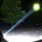 Outdoor LED flashlight beam illuminating a dark path at night, with greenish glow.