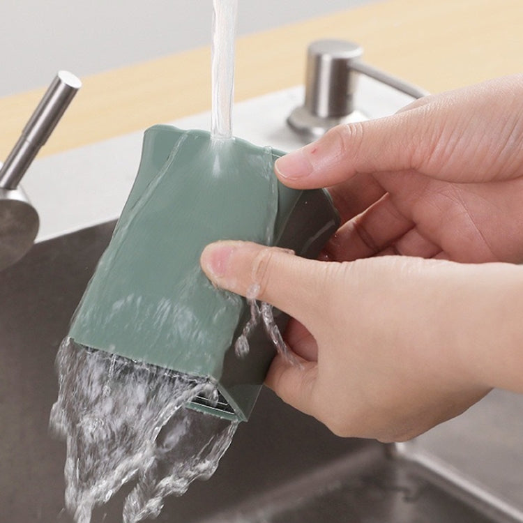Green vegetable slicing cup tool rinsed under running water