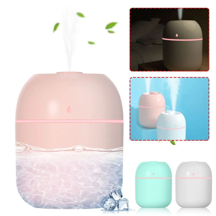 Pink USB humidifier with water splash effect, showing compact cube-like design