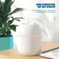 White USB plug-in humidifier with pink LED ring and water-drop indicator