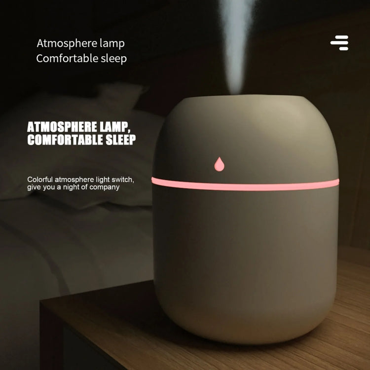 Dark-toned USB plug-in humidifier with pink LED glow and water-drop indicator