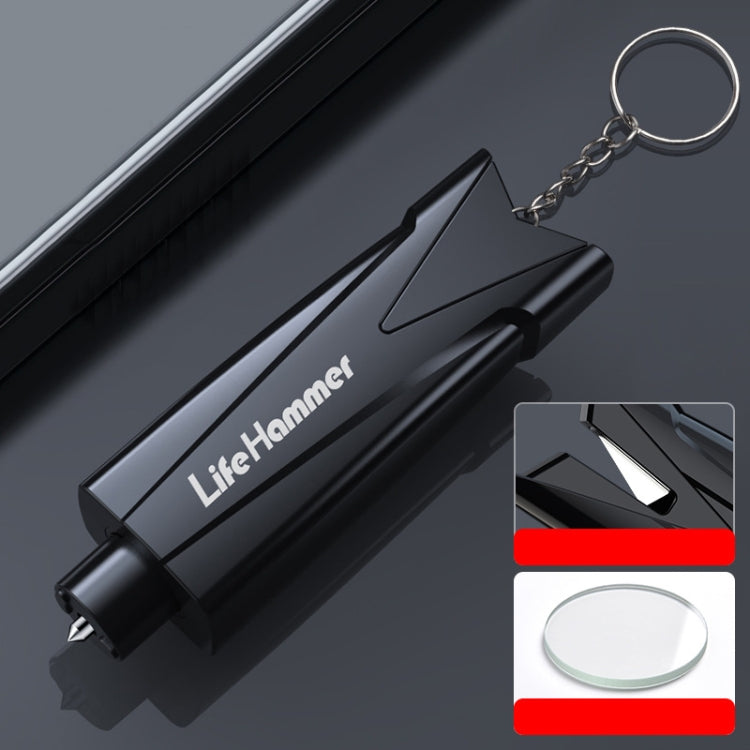 Black emergency window breaker with keyring; side view of pointed glass-breaking tip