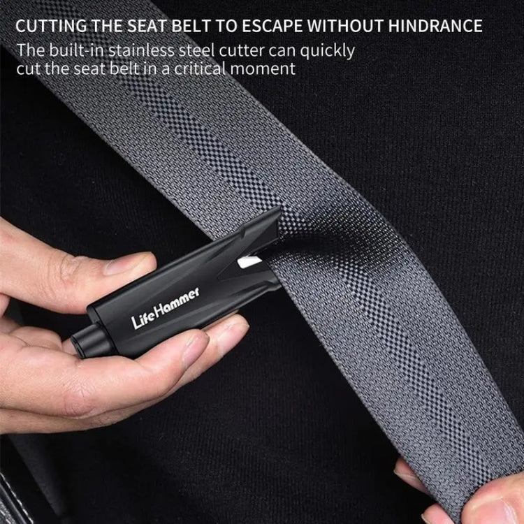 Black emergency window breaker with built-in seat belt cutter, held in hand
