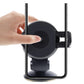 Black suction-cup phone holder with cradle ready for a smartphone; hand pressing base