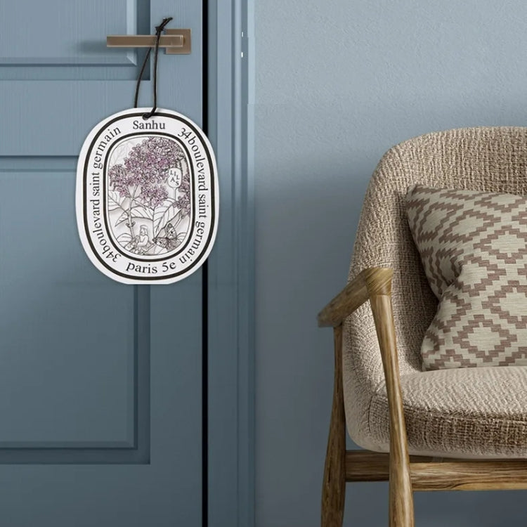 Hanging car fragrance tablet card with circular lavender-toned illustration.