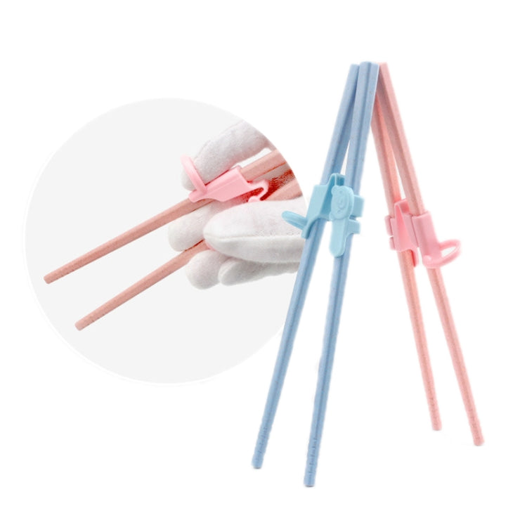 Pink and blue chopstick practice finger cots attached to wooden chopsticks