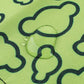 Close-up of green cloud fabric surface with dark outlined clover shapes