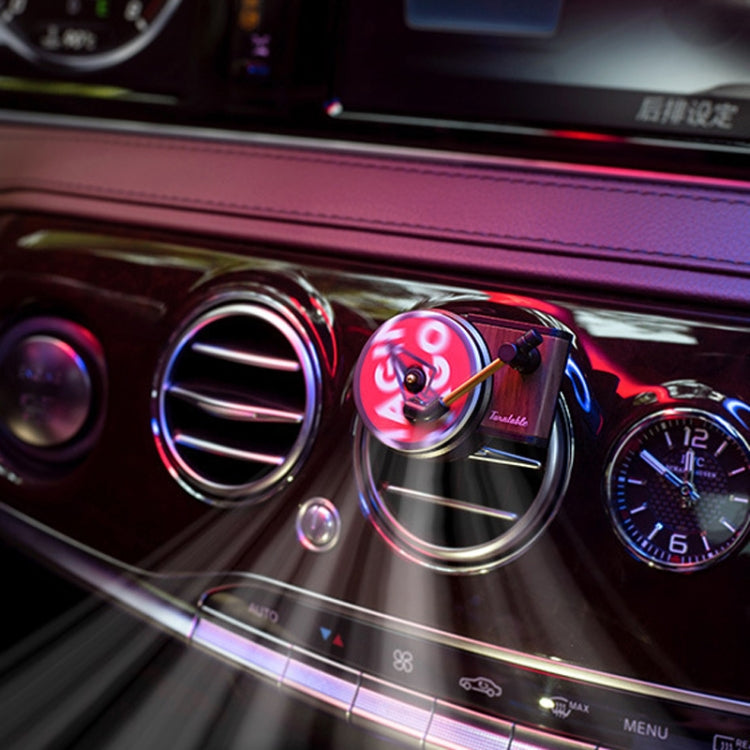 Car air vent fragrance diffuser with spinning vinyl-style ornament clipped to vent