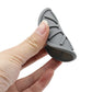 Gray car anti-slip silicone coaster held in hand, round with grip texture