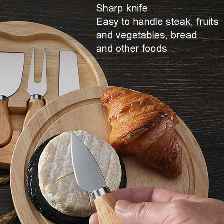 Stainless cheese knife with wood handle and oval blade, paired with a round oak board
