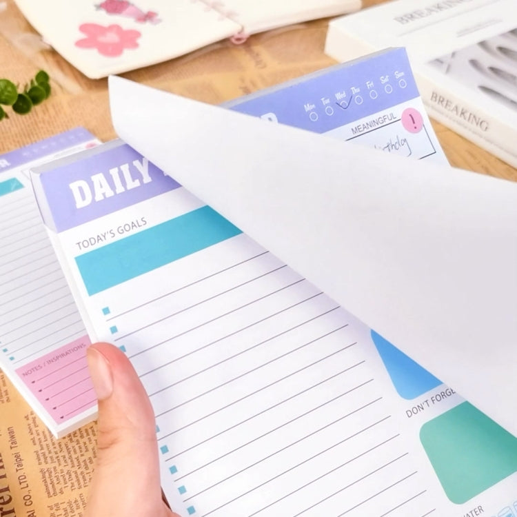 Daily planner notebook with today’s goals section and lined writing rows, handheld