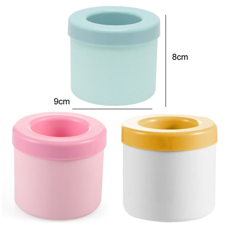 Cylindrical silicone ice cube molds in blue and pink, top openings shown