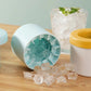 Blue silicone ice cube cup mold showing inner cavity and released ice cubes