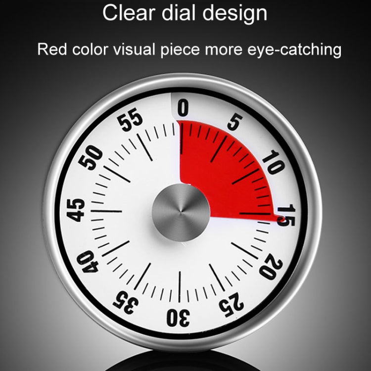 Close-up mechanical kitchen timer dial with red segment and silver center knob