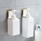 Two white wall-mounted soap dispenser holders with pump bottles, adhesive mounts