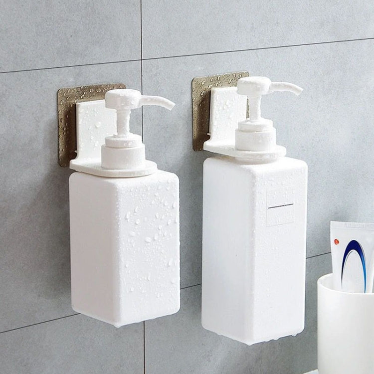 Two white wall-mounted soap dispenser holders with pump bottles, adhesive mounts