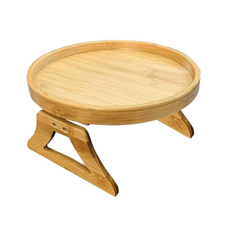 Light wood round serving tray with foldable legs, angled side view.