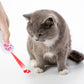 USB rechargeable LED pet projector toy projecting red paw light onto a gray cat