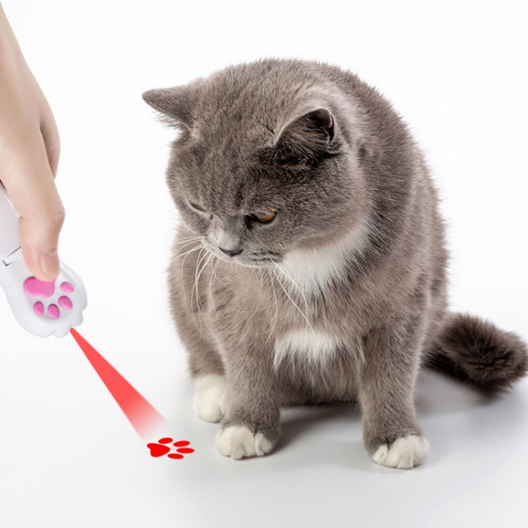 USB rechargeable LED pet projector toy projecting red paw light onto a gray cat