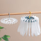 Round laundry sock drying hanger with 20 white clips on a bar